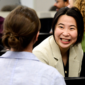 Asian woman introducing herself to another workshop attendee