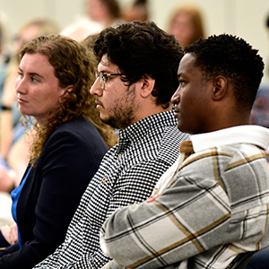 Fellows, left to right, Katherine Patterson, Bryan Ochoa, and Emmanuel Dediavoukana listen to presentations from their peers. (Photo courtesy of Steve McCaw / NIEHS)